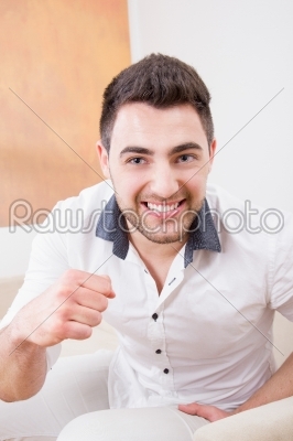 man laughing and showing his fist
