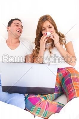 Man laughing at woman with tissue while she is crying