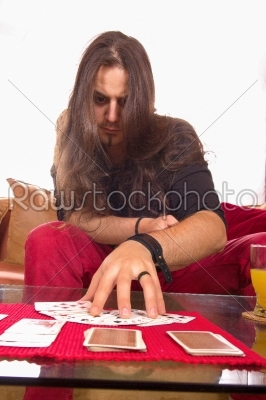 man with a deck of cards on the table in game