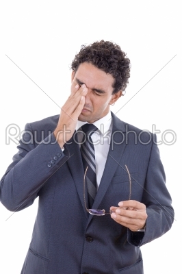 man with a headache holding glasses