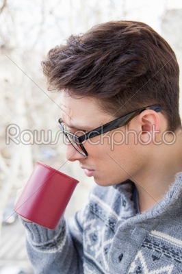 man with glasses drinking coffee