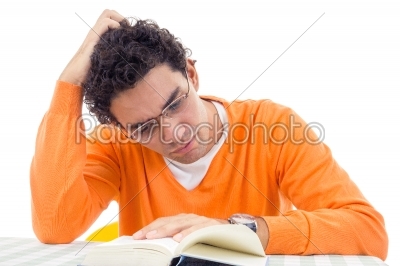 man with glasses in orange sweater reading book