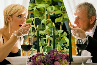 Mature couple eating romantic dinner in a fancy restaurant