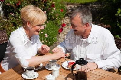 Mature couple having coffee on porch