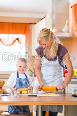 Mother and daughter baking cookies together