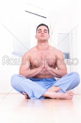 Muscular spiritual man doing yoga