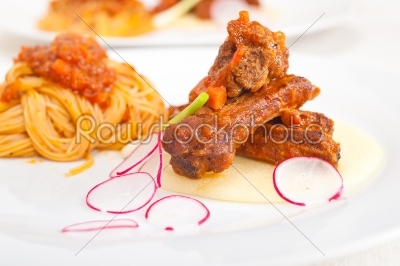 pasta with pork ribbs sauce on polenta bed