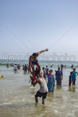 People enjoying beach life of Puri beach in eastern India a holy