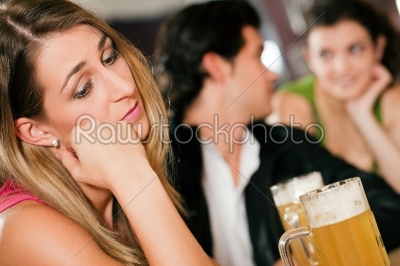 People in bar, woman being abandoned and sad