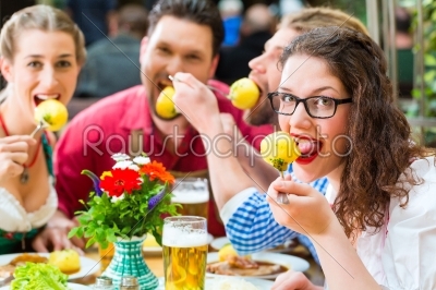 People in bavarian Tracht eating in restaurant or pub