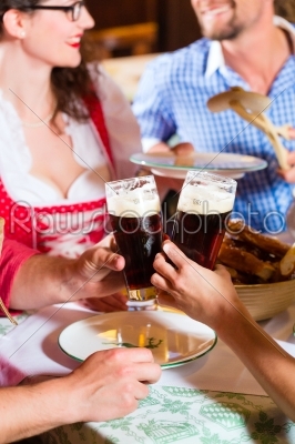 People in Bavarian Tracht eating in restaurant or pub