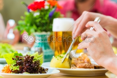 People in bavarian Tracht eating in restaurant or pub