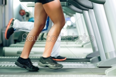 People on treadmill in gym running