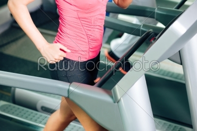 People on treadmill in gym running
