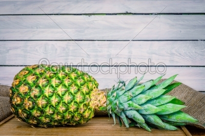 Pineapple on a wooden table with linen