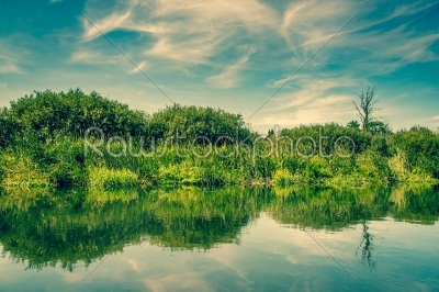 Pond with calm waters and blue sky