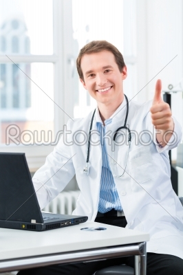Portrait of young doctor in clinic on laptop