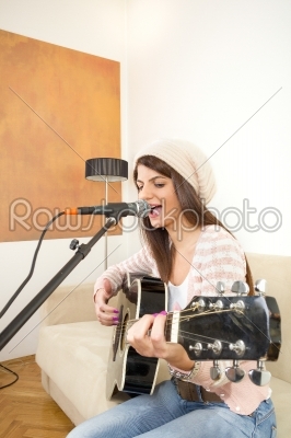 pretty girl singing and playing guitar