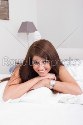 pretty young woman on the bed smiling