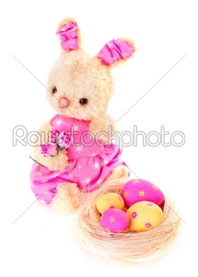 Rabbit bunny toy with eggs on the nest isolated in hand