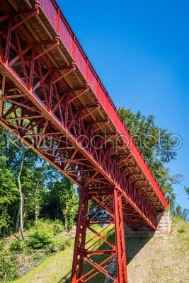 Red metal bridge in the summer