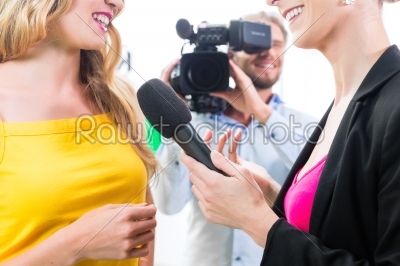 Reporter and cameraman shoot an interview