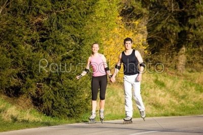 Rollerblading couple outdoors in spring
