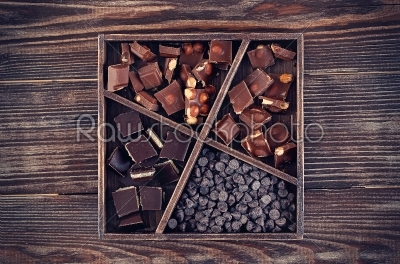 rustic Wood box with set of chocolates  on dark wooden table