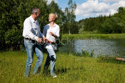 Senior Couple at a lake in summer