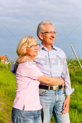 Senior man and woman walking hand in hand