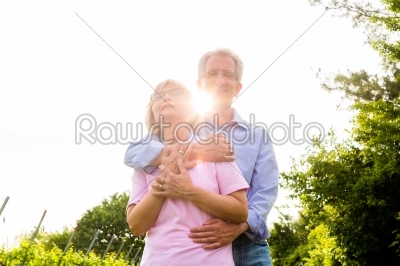Senior man and woman walking hand in hand