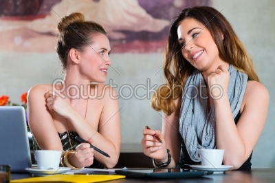 Students or businesswomen working in cafe