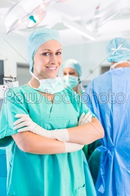 Surgeons operating patient in operation theater