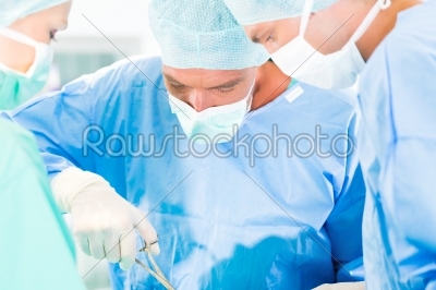 Surgeons or doctors in operating room of hospital
