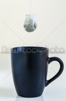 Tea bag is hung in a cup