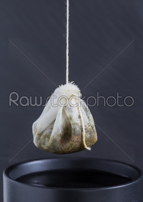 Tea bag is hung in a cup