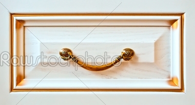 The ancient gold handle on a case door as element of design apartment interior
