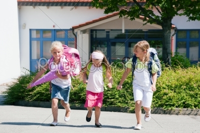 Three schoolchildren having fun