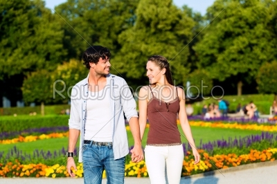 Tourist couple in city park walking