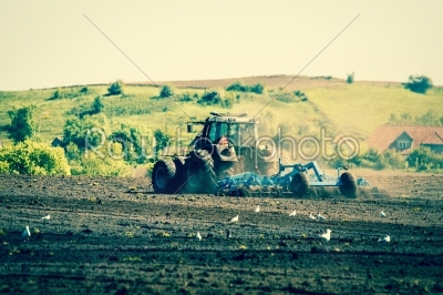 Tractor plowing an agricultural field