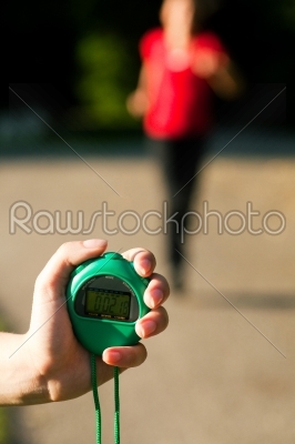 Trainer measuring time of runner
