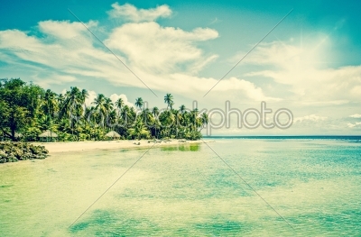 Tropical beach resort at turquoise ocean