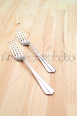 two fork on a pinewood table