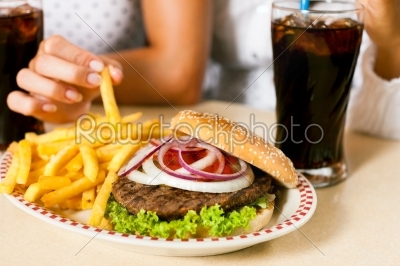 Two women eating hamburger