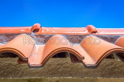 View of red roof tiles and sky on the background