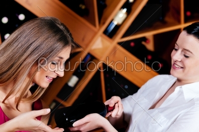 Waitress in restaurant offering red wine