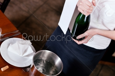 Waitress with Champagne in restaurant