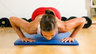 woman doing pushups in gym