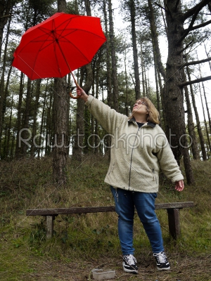 Woman Holding Up a Red Umbrella