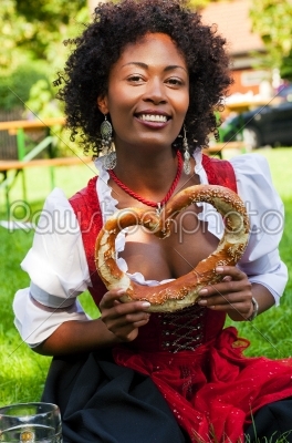 Woman in Dirndl with Bavarian Pretzl